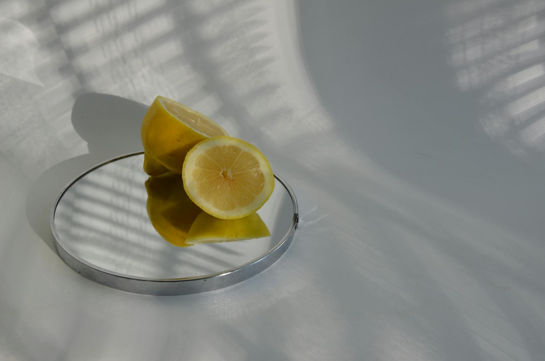 Composizione minimalista con fette di limone su uno specchio con ombre, fotografia minimalista del cibo
